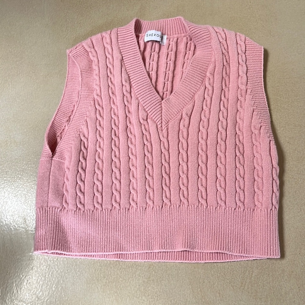 This is a light pink vest/sweater. It’s an xsmall from the brand Shekou.